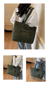 Vue détaillée d'un grand sac cabas matelassé vert avec fermeture éclair et anses