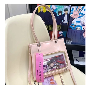 Detailed view of pink Ita Bag with clear PVC display window and anime character badges