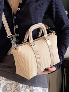 Chic beige woven crossbody bag with khaki leather handles and silver hardware detail