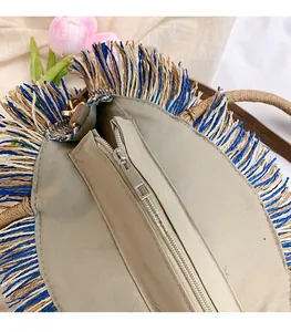 Detail of metal zipper closure and woven texture on a round ethnic tassel bag