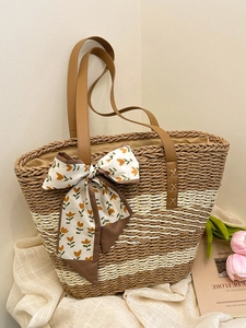 French style woven straw tote bag with brown leather handles and decorative floral silk scarf