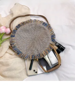 Detail view of woven round bag interior showing spacious storage for makeup and phone