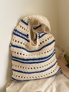 Chic hollow knit tote bag with cream and navy stripes for a casual summer look