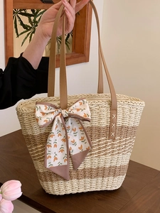 Straw woven tote bag with contrast stripes, leather handles and floral silk bow accessory