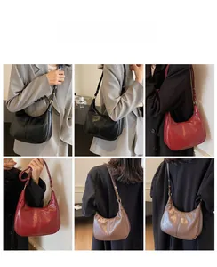 Adjustable shoulder strap detail on leather crescent bags in multiple vintage colors