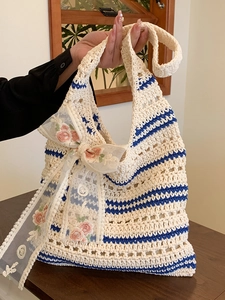 Hollow crochet tote bag with blue stripes and a pink flower lace bow decoration
