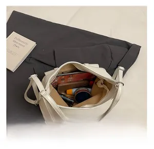 Top view of beige tote bag interior showing ample storage space for tablets and cosmetics