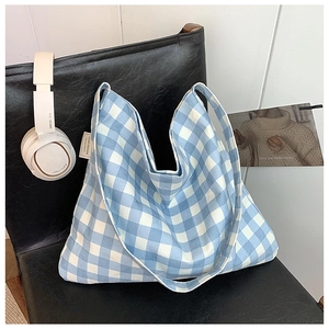Blue and white gingham tote bag displayed on a chair with headphones for a lifestyle view