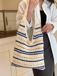 Chic hollow woven tote bag with blue stripes, perfect for casual summer shoulder wear