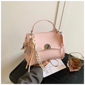 Pink soft leather tote bag detail with metal buckle and decorative striped silk scarf