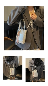 Detail of silver contrast mini phone bag with pleated texture and stylish lanyard