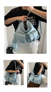 Detail view of light blue faux leather tote bag showing pockets and shoulder strap style