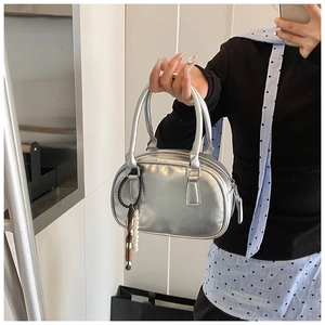 Silver metallic bowling handbag with pearl charm detail and cylindrical handles