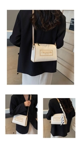 Detail of cream crossbody bag with floral scarf accent and printed fashion typography