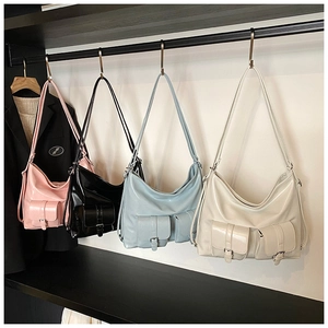 Detail showing four colors of soft faux leather tote bags with front magnetic flap pockets