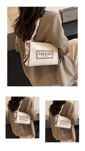 White leather shoulder bag with floral scarf handle detail shown in lifestyle view