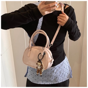 Pink glossy patent leather mini bowling bag with cute doll charm and pearl detail