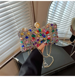 Detailed macro of crystal evening clutch with radial floral pattern and pearl clasp