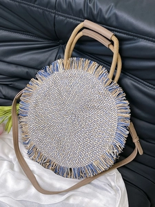 Ethnic style woven round handbag with blue tassels and leather strap for summer vacation
