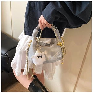 Detail of blue marble cloud bag with ruched handle and white fuzzy monster charm