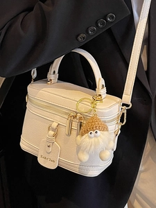 Elegant white lychee leather box bag with gold hardware and plush charm for women