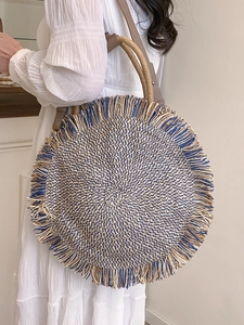 Bohemian large round woven straw bag with colorful stripes, tassels, and shoulder strap