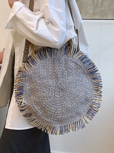 Bohemian round woven crossbody bag with blue fringe tassels and leather straps