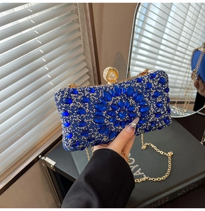 Detail of luxury royal blue rhinestone evening bag with pearl clasp and gold chain