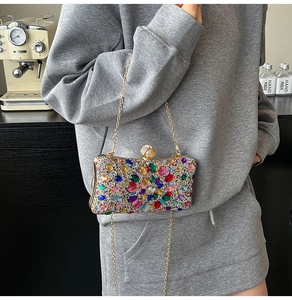 Detailed shot of a luxury evening bag with colorful crystals and pearl clasp detail