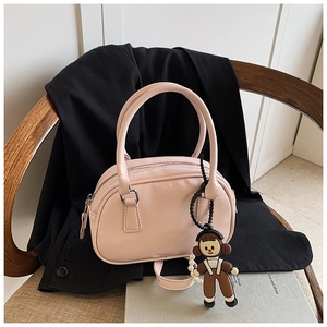 Pink patent leather bowling bag with cute cartoon girl and pearl charm on a black blazer