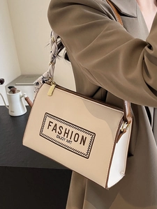 Chic two-tone shoulder bag in cream and brown leather with elegant silk scarf accent