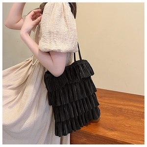 Détail rapproché du sac cabas noir à volants superposés avec texture plissée chic