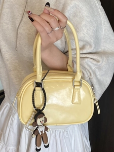 Glossy yellow bowling handbag with cute cartoon doll pendant and white pearl chain