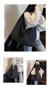 Detail view of large black waterproof nylon tote bag showing spacious capacity and drape