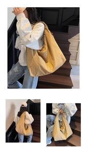 Detailed view of the large ginger yellow hobo bag showing nylon texture and side zipper