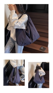 Deep blue nylon hobo tote bag featuring a textured finish and spacious minimalist design