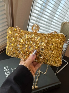 Luxury gold evening clutch bag with sparkling crystals and pearl clasp for elegant parties