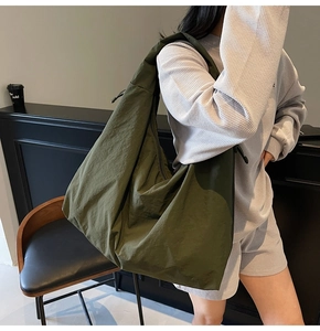 Detail of olive green hobo bag featuring crinkled fabric texture and drawstring accents
