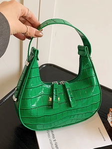 Bright green crocodile pattern crescent hobo bag with glossy finish and silver zippers