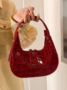Fashionable dark red crocodile pattern crescent handbag with a glossy patent finish