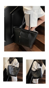 Detail view of large black PU leather tote bag with functional front zipper pocket