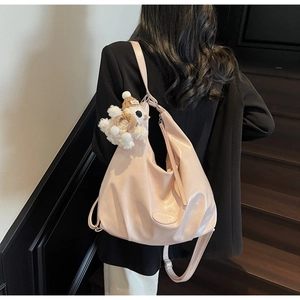 Détail du grand sac cabas en cuir souple avec breloque ours sur l'épaule