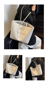 Detail of white tote bag with front zipper pocket and thin double shoulder straps