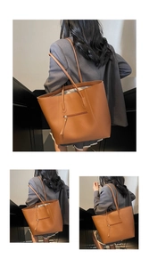 Detail view of large brown faux leather tote bag with stylish decorative front zipper