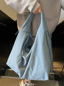 Chic light blue slouchy tote bag made of crinkled nylon for casual daily commute