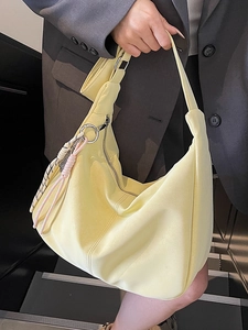 Lemon yellow hobo tote bag with woven detail and large capacity shown on model