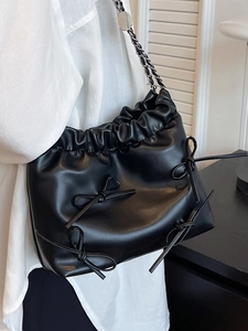 Chic black soft leather tote bag with bow details and stylish silver chain strap