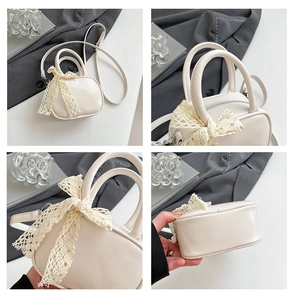 Detail view of mini cream white crossbody bag with delicate lace bow and leather texture