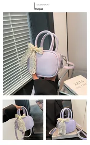 Detailed view of purple mini crossbody bag with a cream lace bow and smooth leather finish