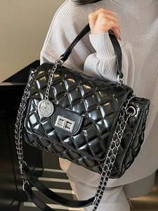 Elegant black quilted crossbody bag with silver chain strap and top handle for women